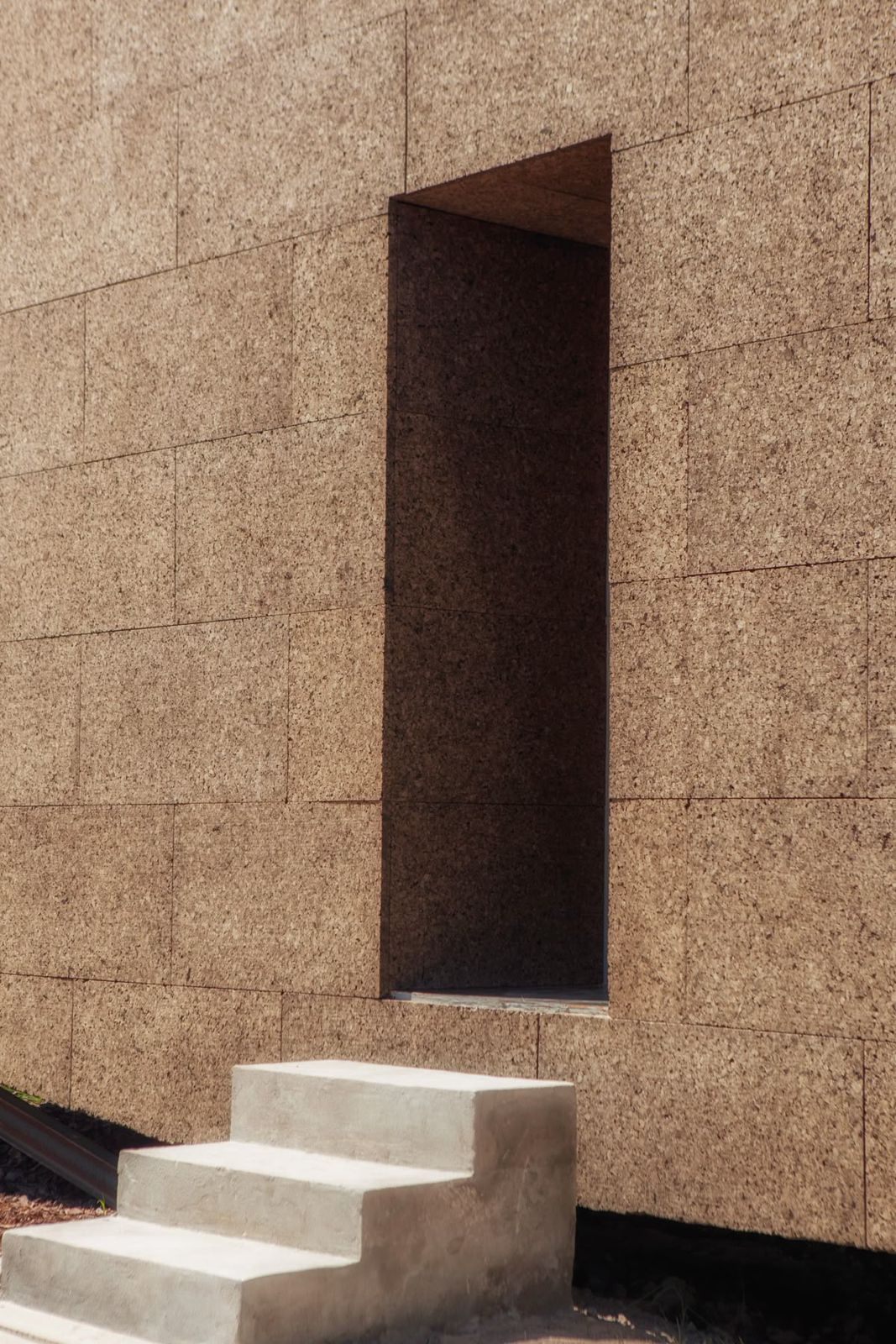 Cork-clad wall with stone steps